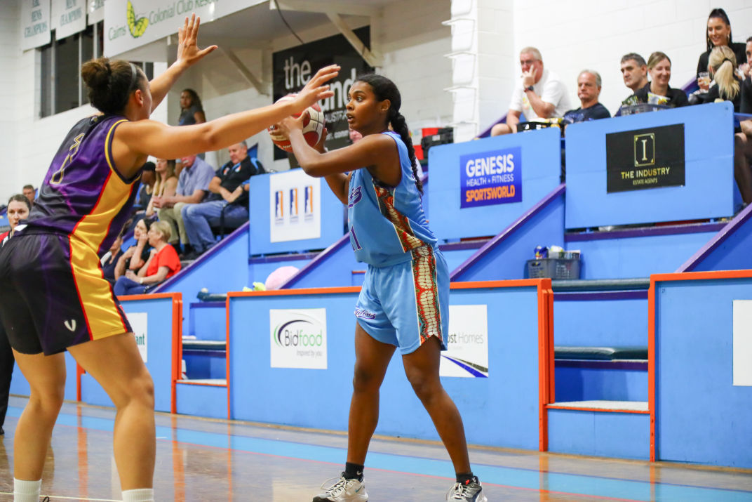 Basketball player Ashley Taia preparing to shoot from the free throw line. 